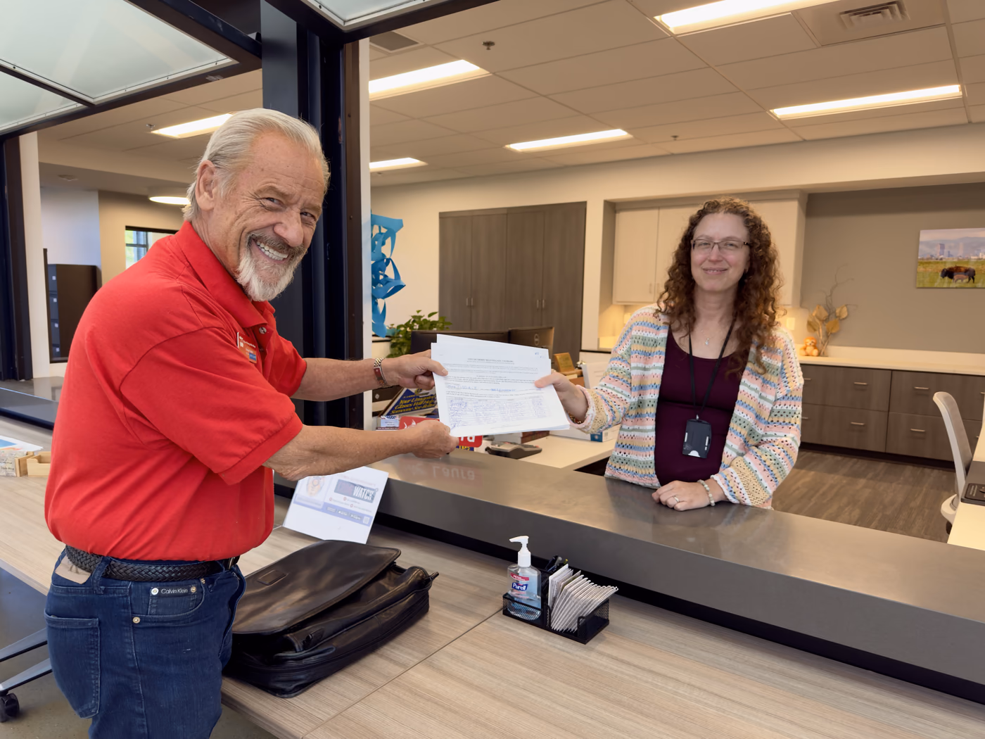 Former Mayor Doug Tisdale hands his nominating petitions to Cherry Hills Village City Clerk Laura Gillespie