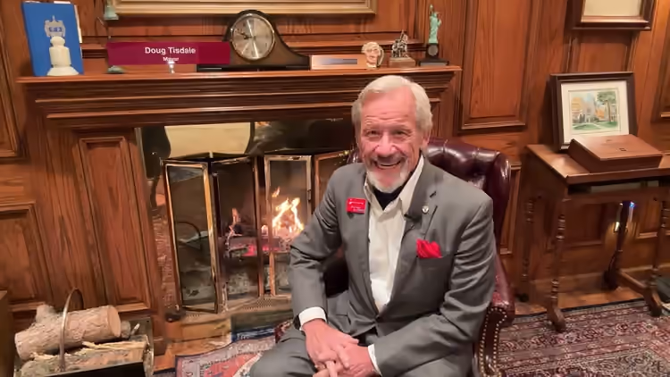 Doug seated beside the fireplace for his second Fireside Chat